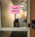 Staff Only sign on safety glass in a medical clinic