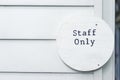 Staff only sign on wooden white door and kitchen entrance, inside workplace, copy space