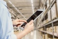 Staff using tablet with smart warehouse tracking inventory management and monitor control logistic system Royalty Free Stock Photo