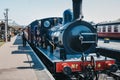 Staff walking on platform next to The Poppy Line steam train, Sheringham, Norfolk, UK Royalty Free Stock Photo