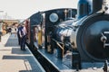 Staff walking on platform next to The Poppy Line steam train, Sheringham,  Nortfolk, UK Royalty Free Stock Photo