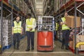 Staff at work in the aisle of a busy distribution warehouse Royalty Free Stock Photo