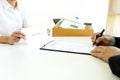 Staff worker hold the box and send resignation letter to boss