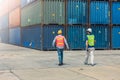 Staff worker lunch break walking security check in large cargo goods warehouse port loading containers are for shipping import