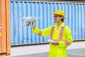 Staff worker using Drone aerial imaging system in port container yard. UAV Patrol flying guard technology for survey and security