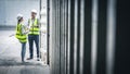 Staff workers inspecting shipping container. Royalty Free Stock Photo