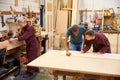 Staff Working In Busy Carpentry Workshop