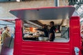 Staff working at an Indian street food inside Spitalfields Market, London, UK