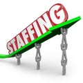 Staffing Word Arrow Lifted by Employees Workers Hires Royalty Free Stock Photo