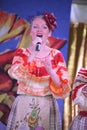 On the stage beautiful girls in national Russian costumes, gowns sundresses with vibrant embroidery - folk-music group the Wheel. Royalty Free Stock Photo