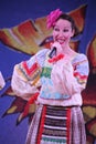 On the stage beautiful girls in national Russian costumes, gowns sundresses with vibrant embroidery - folk-music group the Wheel. Royalty Free Stock Photo