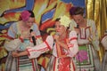 On the stage beautiful girls in national Russian costumes, gowns sundresses with vibrant embroidery - folk-music group the Wheel. Royalty Free Stock Photo