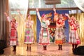 On the stage beautiful girls in national Russian costumes, gowns sundresses with vibrant embroidery - folk-music group the Wheel. Royalty Free Stock Photo