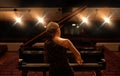 Stage, concert and back of woman with piano for performance, entertainment and talent show. Musician, pianist and person Royalty Free Stock Photo