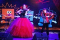 On stage, the expressive red-haired violinist Maria Bessonova sons twins. violin trio two generations of red fiery musicians.