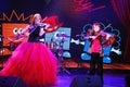 On stage, the expressive red-haired violinist Maria Bessonova sons twins. violin trio two generations of red fiery musicians. Royalty Free Stock Photo