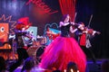 On stage, the expressive red-haired violinist Maria Bessonova sons twins. violin trio two generations of red fiery musicians. Royalty Free Stock Photo