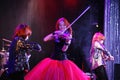 On stage, the expressive red-haired violinist Maria Bessonova sons twins. violin trio two generations of red fiery musicians. Royalty Free Stock Photo