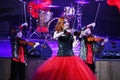 On stage, the expressive red-haired violinist Maria Bessonova sons twins. violin trio two generations of red fiery musicians.