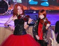 On stage, the expressive red-haired violinist Maria Bessonova sons twins. violin trio two generations of red fiery musicians.