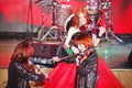 On stage, the expressive red-haired violinist Maria Bessonova sons twins. violin trio two generations of red fiery musicians.