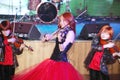 On stage, the expressive red-haired violinist Maria Bessonova sons twins. violin trio two generations of red fiery musicians. Royalty Free Stock Photo