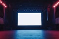 A large blank screen on stage in a concert hall with colorful lights in a dark setting ready for an event or Royalty Free Stock Photo