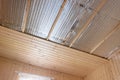 Stage of finishing clapboard ceiling in a country house Royalty Free Stock Photo