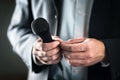 Stage fright concept. Nervous and shy public speaker with microphone. Business man afraid of giving speech for crowd of people. Royalty Free Stock Photo