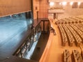 stage of the large auditorium of the CCB with the opening open to the technical area with 2 people nearby, Portugal.