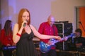 On stage, the musicians pop-rock group Spearmint and singer Anna Malysheva. red . Red headed Glam Rock Girl singing. Royalty Free Stock Photo