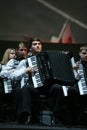 On stage, the musicians and soloists of Orchestra of accordionists (harmonic orchestra) under the baton of conductor. Royalty Free Stock Photo