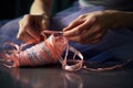 stage of sewing ribbons onto ballet pointe shoes