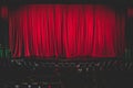 Stage with velvet red curtain in theater cinema, empty old-fashioned elegant theatre wooden stage with red cloth drapes curtains Royalty Free Stock Photo