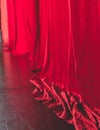 Stage with velvet red curtain in theater cinema, empty old-fashioned elegant theatre wooden stage with red cloth drapes curtains