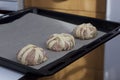 Stages of preparation of meat glomeruli. The blanks are laid out on a baking tray lined with food paper Royalty Free Stock Photo