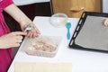 Stages of preparation of meat glomeruli. A woman forms minced meat. Next to the table is a dough and tools Royalty Free Stock Photo