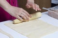 Stages of preparation of meat glomeruli. A woman rolls out the dough. Next to the table is a stuffing and lie tools Royalty Free Stock Photo