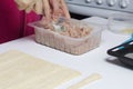 Stages of preparation of meat glomeruli. A woman stirs stuffing. Next to the table is a dough and tools Royalty Free Stock Photo