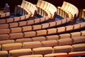 Staggered rows of plush audience seats in shades of cream