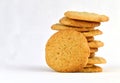 Staggered stack of homemade peanut butter cookies with one resting against it.