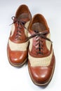 Staggered view of a pair of vintage men`s shoes in brown leather Royalty Free Stock Photo