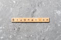Stagnation word written on wood block. stagnation text on cement table for your desing, concept Royalty Free Stock Photo