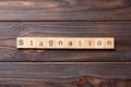 stagnation word written on wood block. stagnation text on cement table for your desing, concept Royalty Free Stock Photo