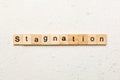 stagnation word written on wood block. stagnation text on cement table for your desing, concept Royalty Free Stock Photo