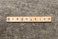 stagnation word written on wood block. stagnation text on cement table for your desing, concept Royalty Free Stock Photo