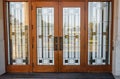 Stain glass door. Front Entrance of a traditional house with mission style stained wood door. Glass front door Royalty Free Stock Photo