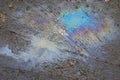 A stain of oil or gasoline in a puddle on the ground Royalty Free Stock Photo