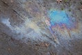 A stain of oil or gasoline in a puddle on the ground Royalty Free Stock Photo