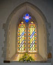 Stained glass arch window. Fresh flowers Royalty Free Stock Photo